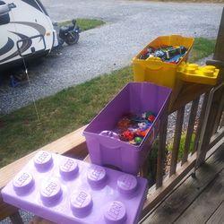Two LEGO bins. One Filled Near Overflowing, One w/ miscellaneous toys.