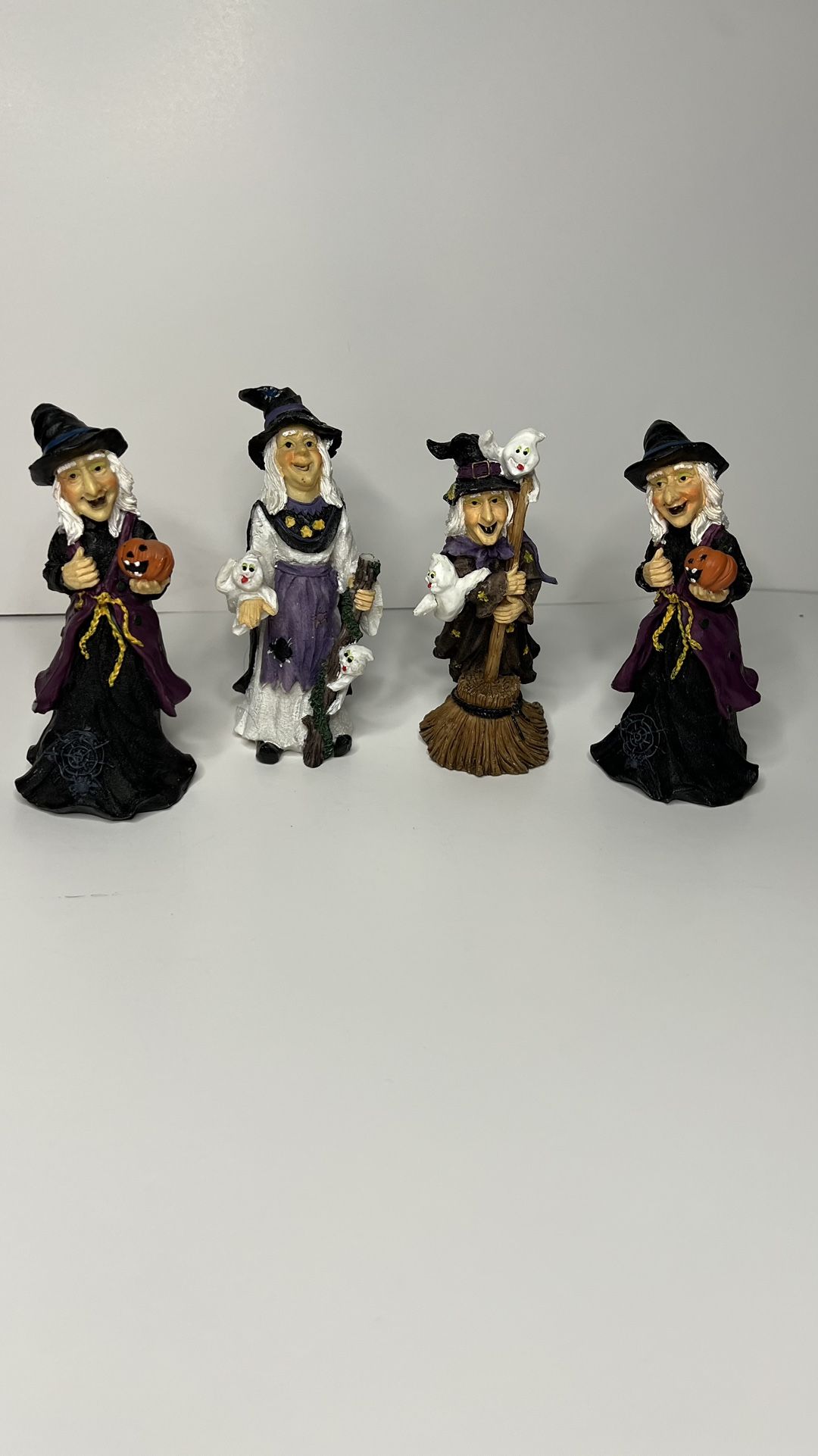 Set of 4 spooky Halloween witches figurines in purple and black