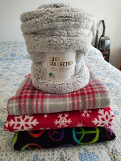 Set of fleece. New regular size and 3 large lap blankets. Shown on queen size bed so you see they are good size.
