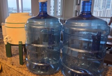 Two 5 gallon water bottles and spout