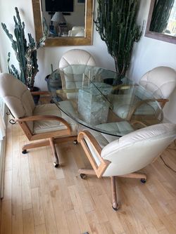 Beautiful Glass Dining Table with 4 Rolling Chairs