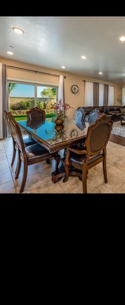 Dinning table, glass top and leather chairs