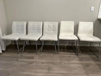 5 White Faux Leather Chairs.
They are of 2 different styles.