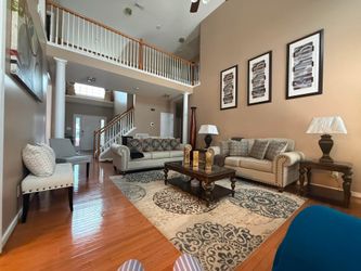 Three piece cream colored cloth living room set