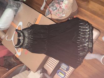 White House Black Market sleeveless short black dress features a blouson top, a cinched elastic waist, and intricate gold and silver beaded embellishm