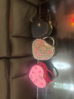 A lot of three heart coach purses