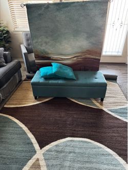 Rug , storage ottoman , and wall tapestry