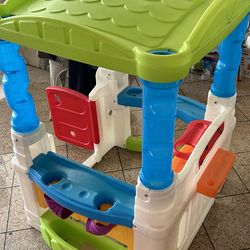 Kids play house with some plastic balls