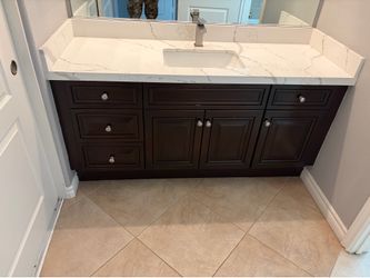 Vanity cabinets, sink, countertops and faucets.