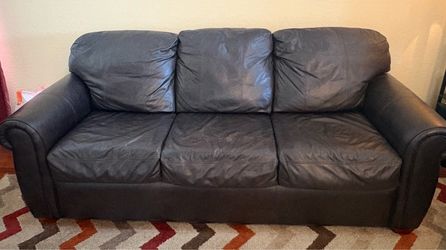 Dark brown leather sofa and armchair