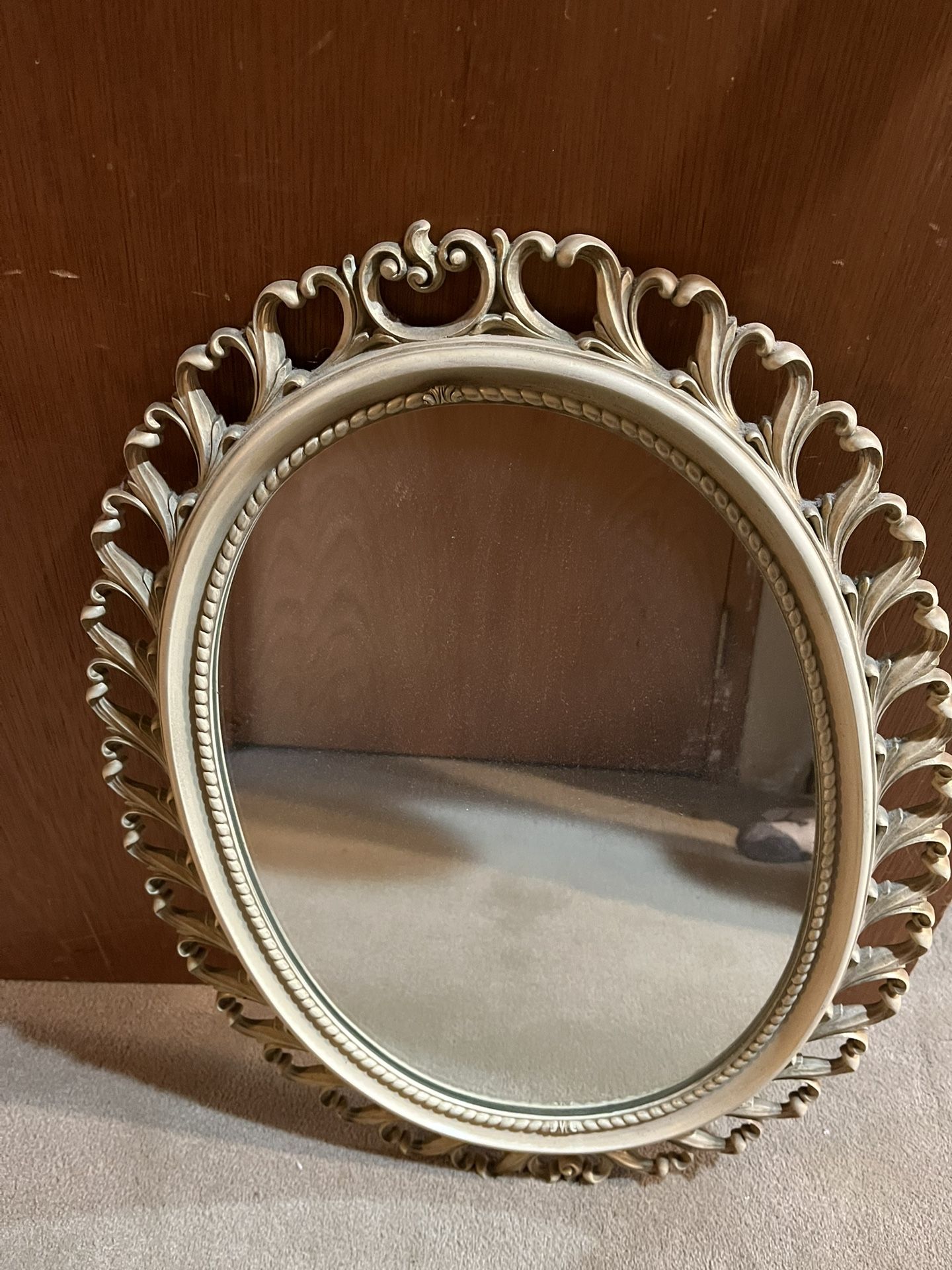 Antique mirror, 24 inches tall 18 inches wide in a bone white paint on wood construction