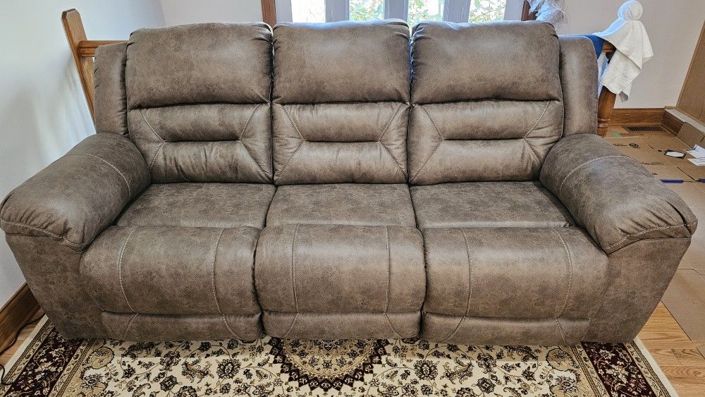 Brand New Reclining three seat power sofa.