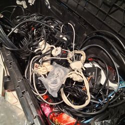 3 D Printer Parts With a Bin Full Of Cords And Chargers