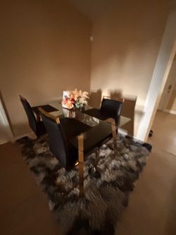 Glass Top Dining Table with 4 Black and Gold Chairs