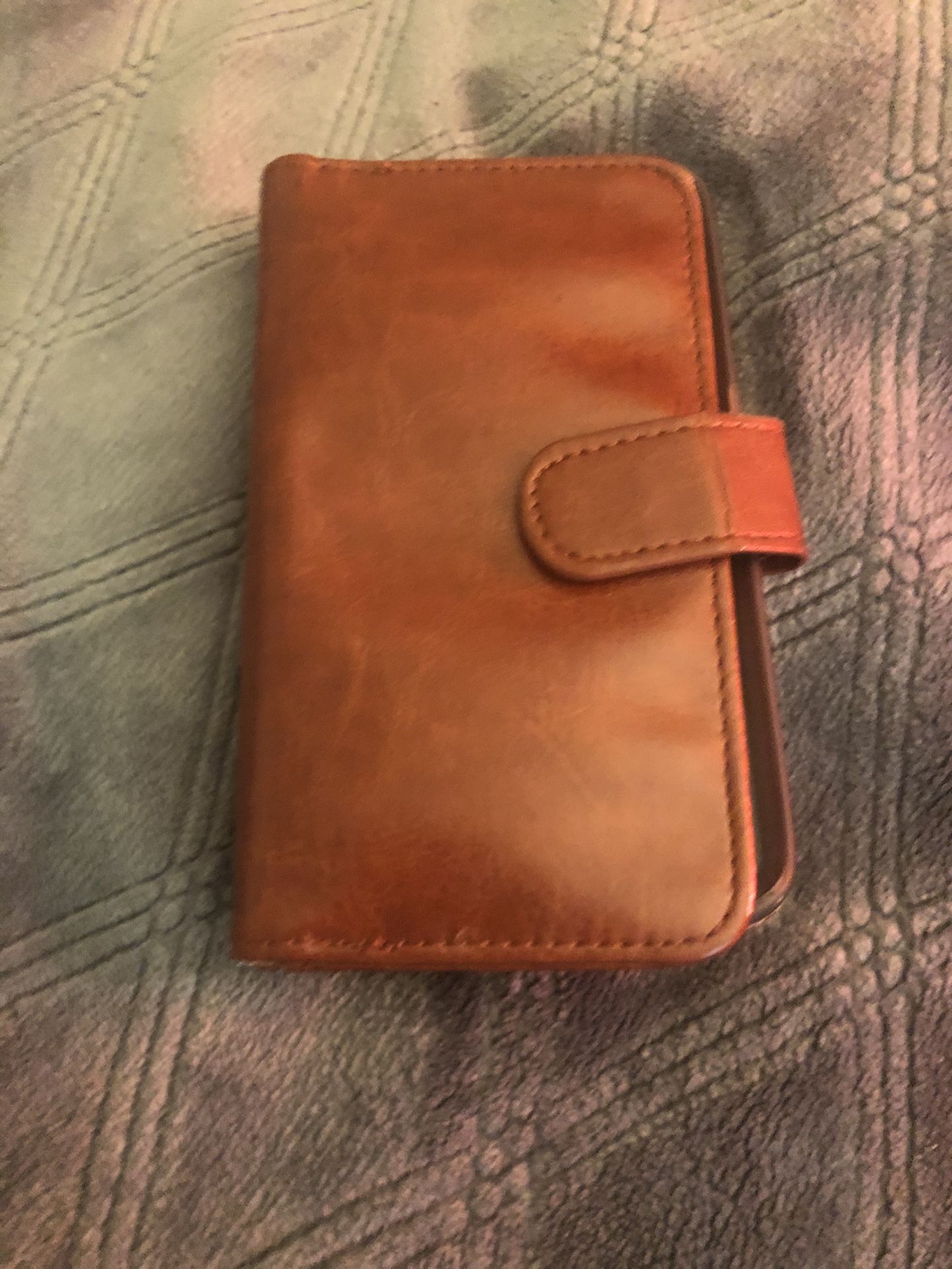 Brown android ( or some type ) or Microsoft Samsung phone wallet case