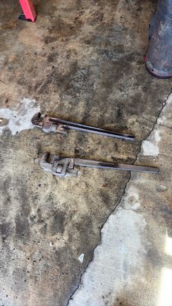 2 foot pipe wrenches. One is rigid, the other is Trimo.
