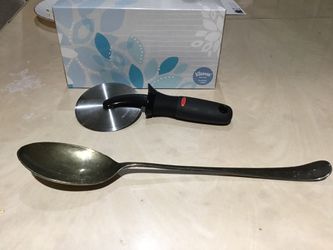 Kitchen utensils serving spoon, pizza wheel