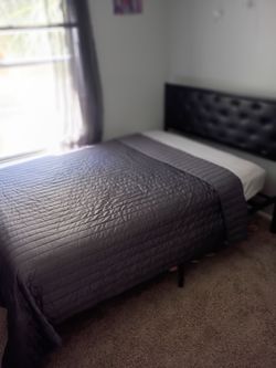 Comfortable full size bed with bedding & headboard