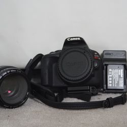 Canon Sl1 With 50mm 1.4 Batteries And Charger And Hand Strap