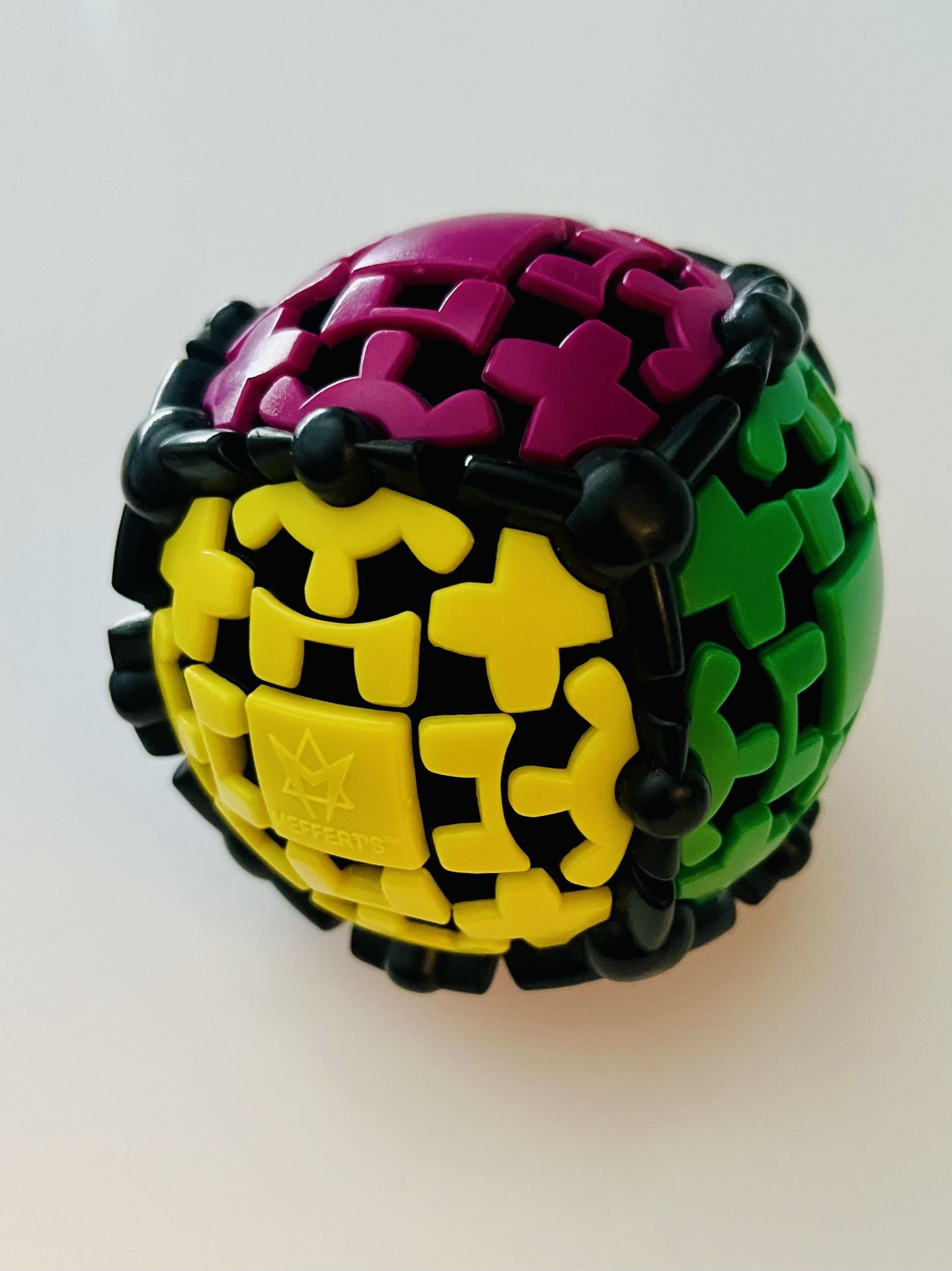 The Meffert's Gear Ball is a spherical puzzle with interconnecting gears that rotates, allowing you to solve it by aligning all six faces with a singl
