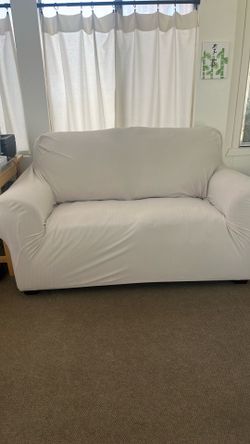 Love Seat with slip cover.  Underneath is a brown leather which is in good condition.