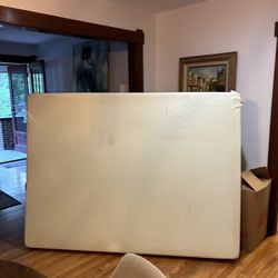 White queen-sized mattress with  box spring