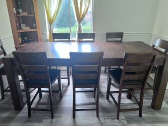 Large wooden table with 8 chairs