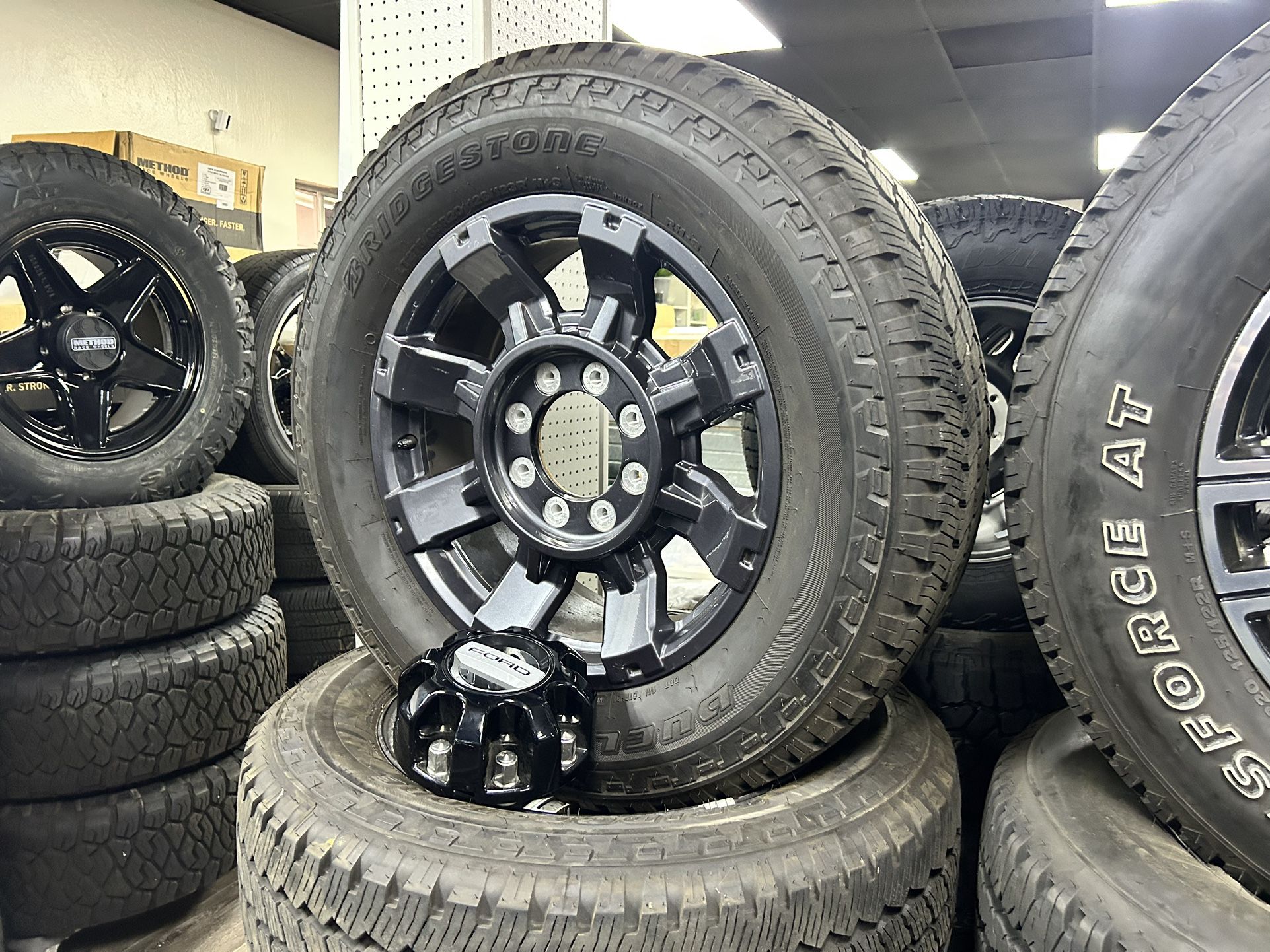 We install - 2025 Ford F250 wheels f-350 rims Bridgestone AT LT275/65R20 99% Tread