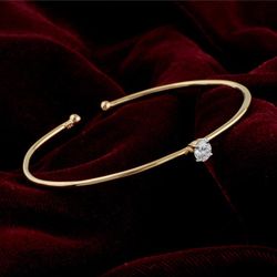 Elegant Gold-Tone Bangle Bracelet with Clear Solitaire Stone
