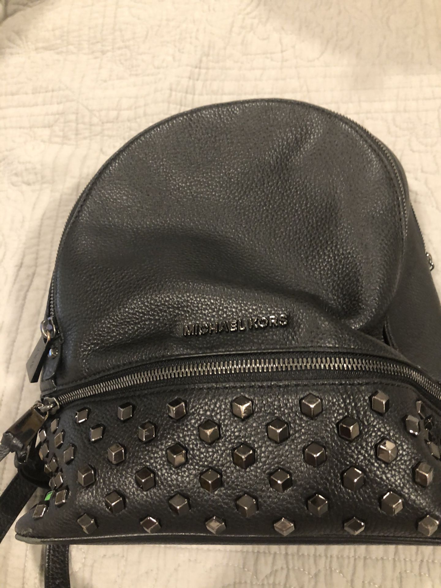 Michael Kors backpack with multiple compartments in gread condition with beaded studs. .