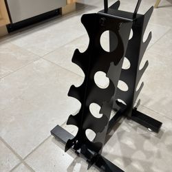 New 4 tier dumbbell rack. weight for dumbbell is 5-15 pounds. met a- frame with handle 