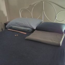 Wrought iron headboard and footboard, painted white.