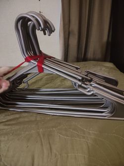 21 silverish grey plastic hangers