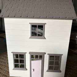 Pottery Barn Doll House With Dolls And Everything In The House That Is Shown In The Photo