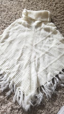 Cream knitted poncho sweater.