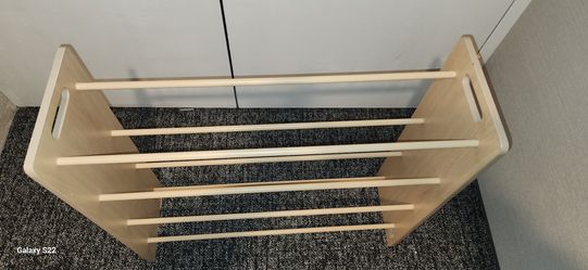 natural wood, multi-tier dowel rack used for storing shoes