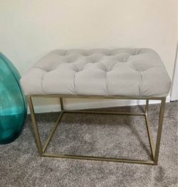 Gray upholstered metal bench