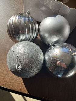 Four Large Silver Plastic Ornaments