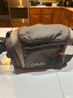 Cabela's Catch-All Gear Bag, a durable and weather-resistant ripstop utility bag featuring multiple zippered compartments and the distinctive Cabela's