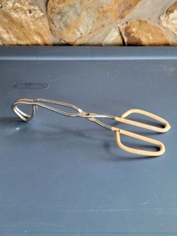 Ekco vintage scissor-style tongs with stainless steel construction and beige comfort-grip handles