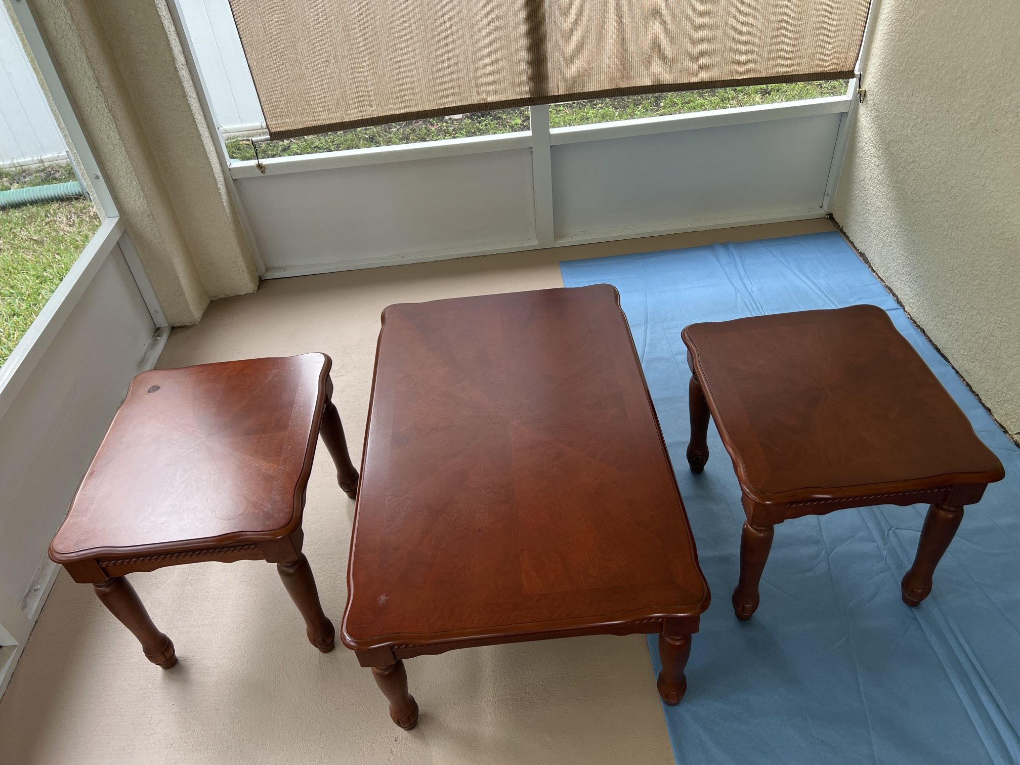 A wooden three-piece end table set