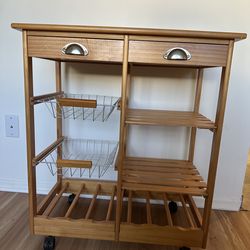 Kitc rack with 2 drawers, 2 baskets, 2 shelves and 6 Wine bottle rack on wheels. Excellent condition.