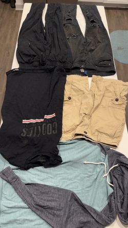 $5 each 12 Pc Men's assorted clothes 3pants/1shorts 8 tops - Medium Sized