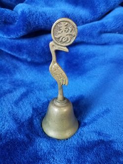 Brass bell with crane on top and Chinese symbol on crane bill