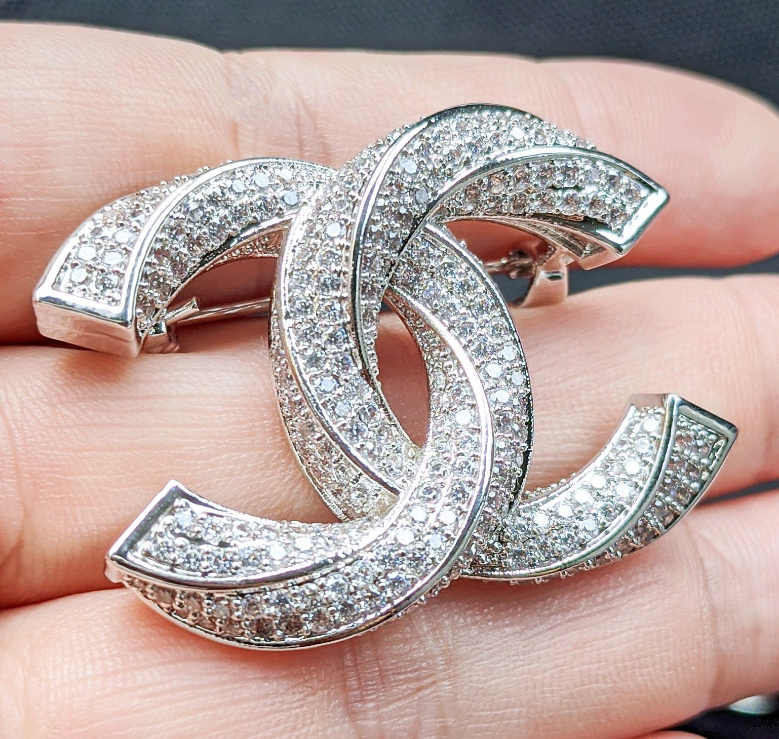 New silver tone crystals filled brooch