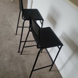To high black plastic chairs