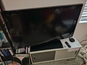 Samsung TV, bookcase stand, and Roku