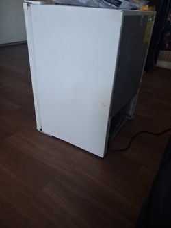 Mini refrigerator and regular size fridge