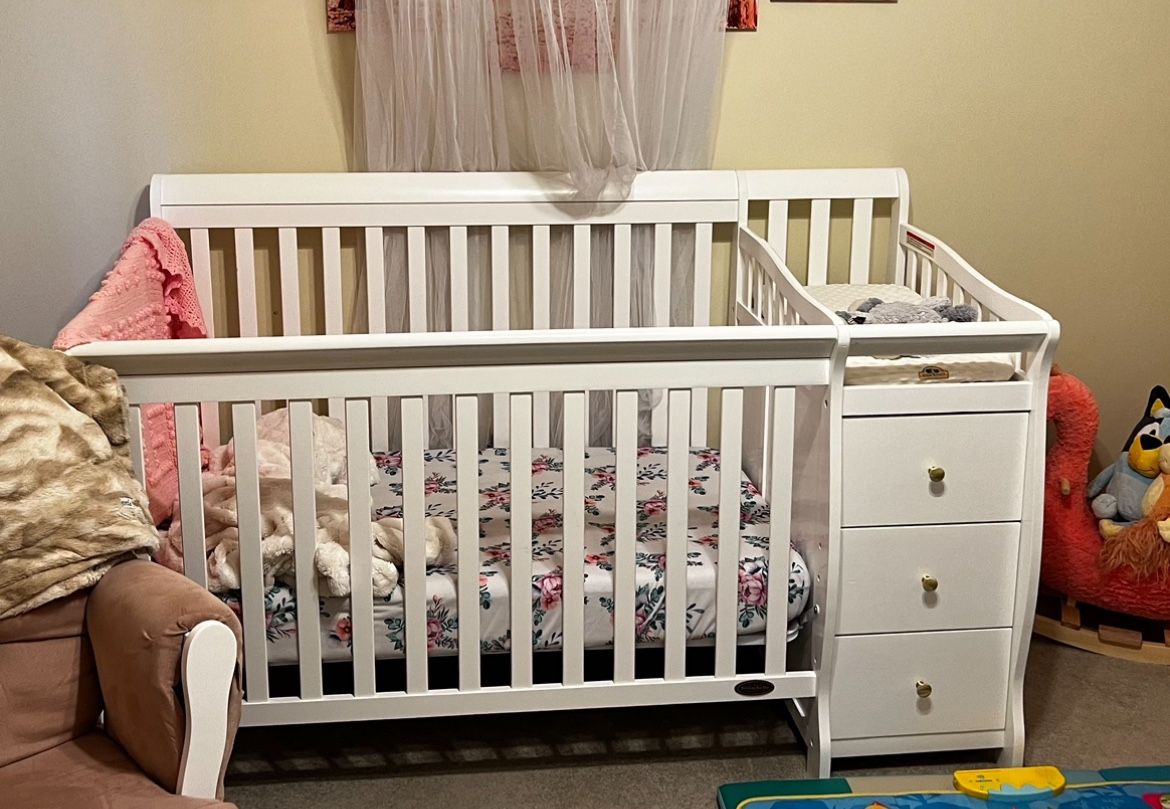 Convertible crib with changing table and drawers, jungle jumperoo, swing, and large playpen