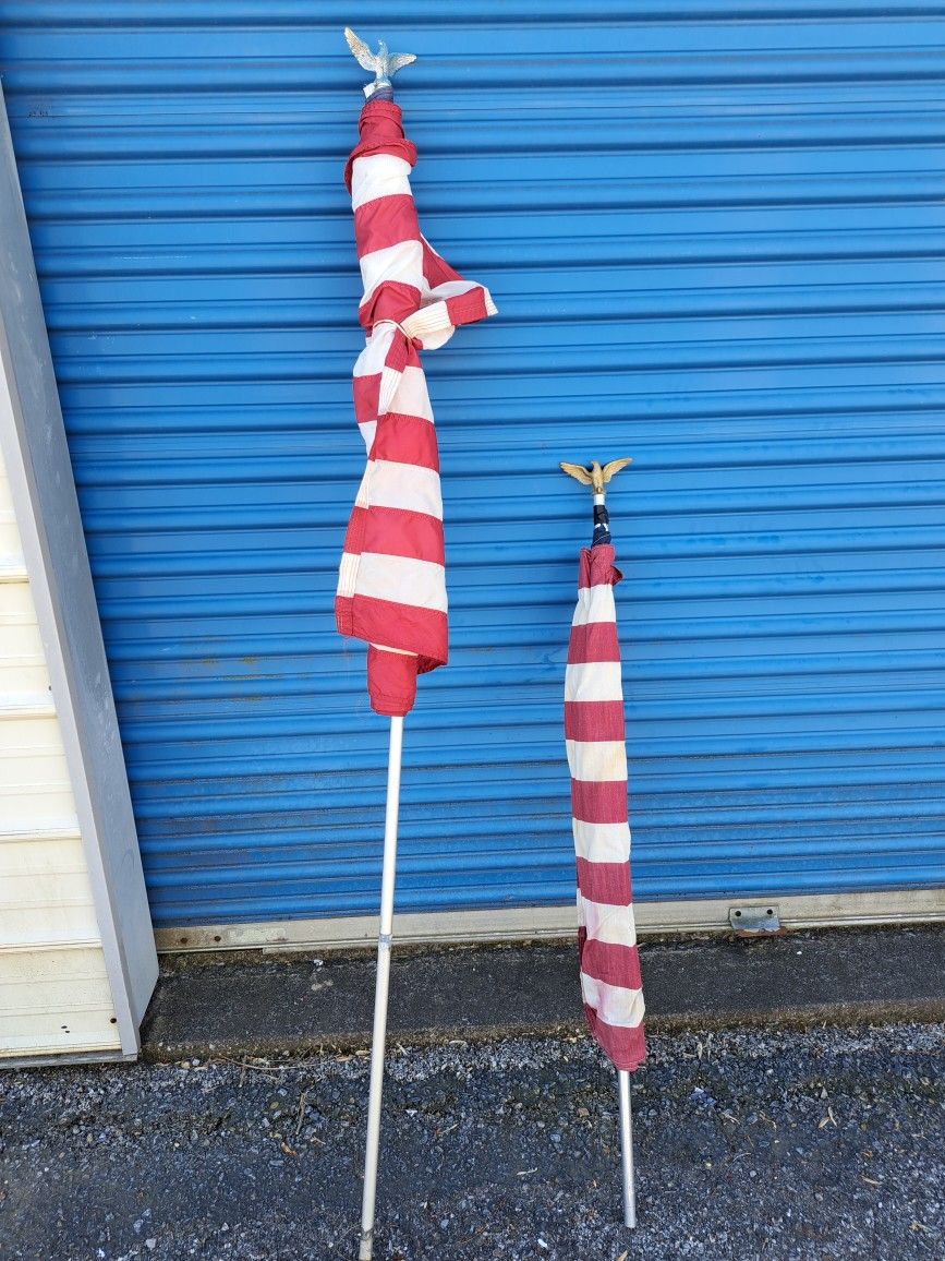 2 American flags with eagles and poles